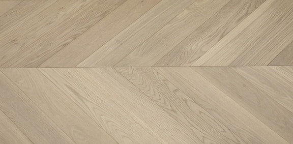 A close up of Moonlight VIDAR premium American oak engineered hardwood flooring in chevron.