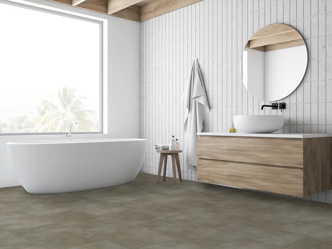 Modern bathroom with a freestanding bathtub, wooden vanity, and round mirror.