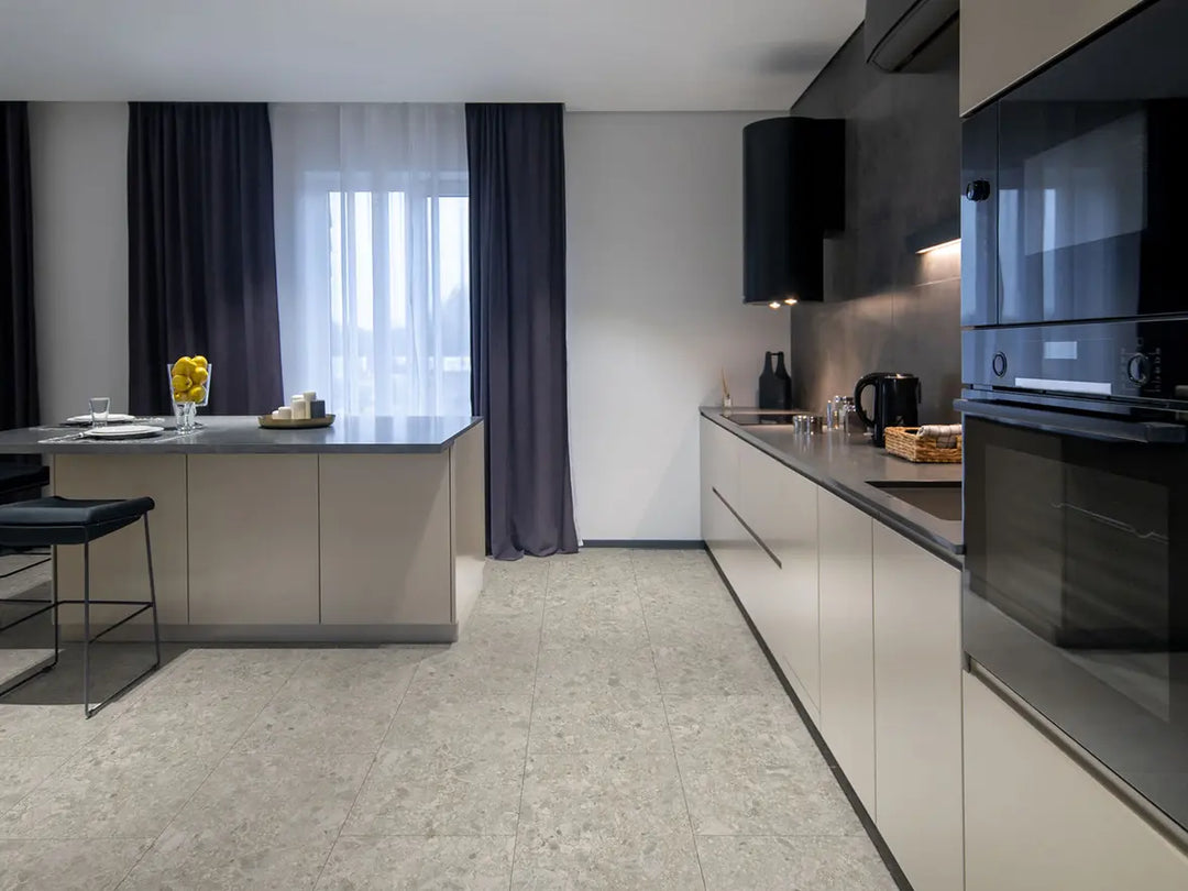 Modern kitchen with white cabinetry, black appliances, and a window with curtains.