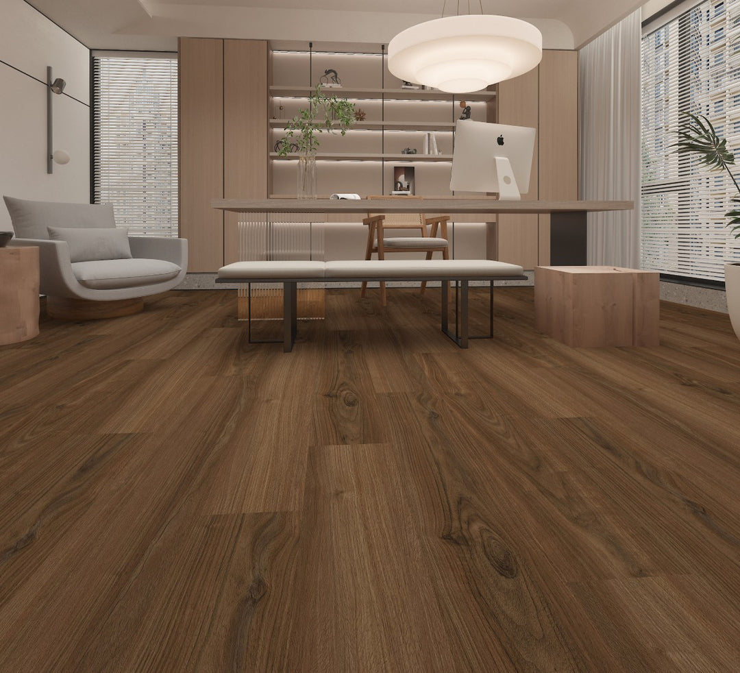 Brown wood-look laminate or vinyl flooring shown installed in a modern, minimalist living room with a desk, computer, and lounge chair.