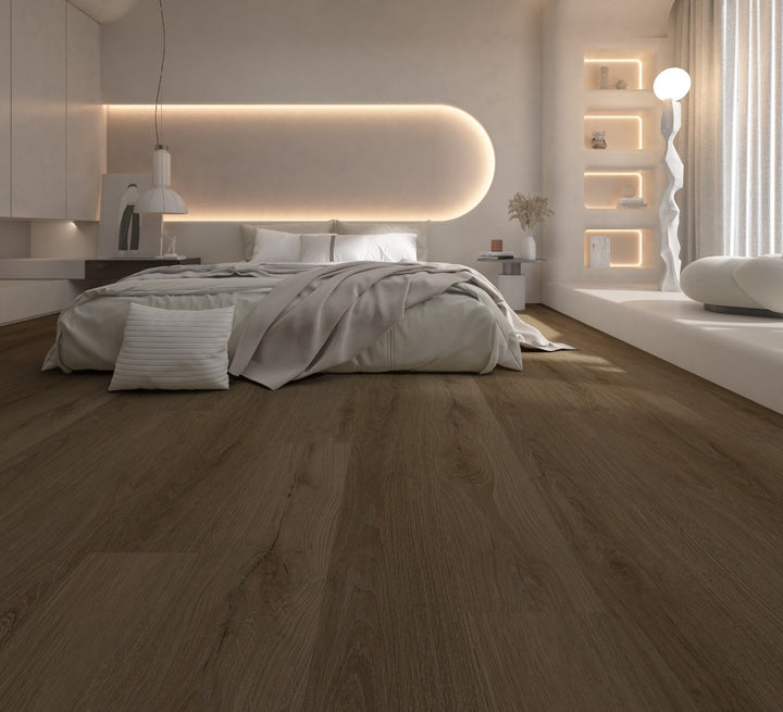 A modern bedroom interior with a bed dressed in light neutral bedding, set in a bright minimalist room with warm ambient lighting, built-in shelves, and a large wood-look floor that dominates the foreground.
