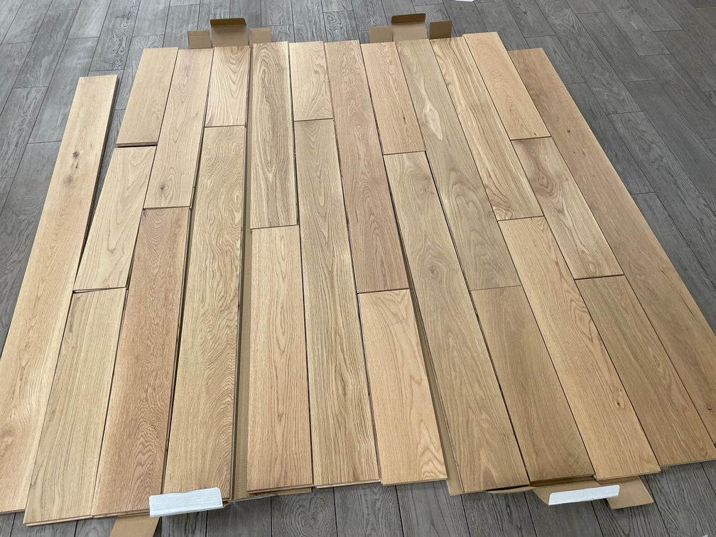 Planks of Honey Wheat VIDAR premium American Hickory engineered hardwood flooring.