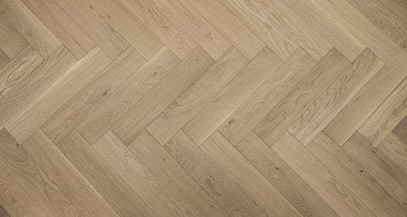 A close up of Honey Wheat VIDAR premium 5” American white oak engineered hardwood flooring in herringbone.