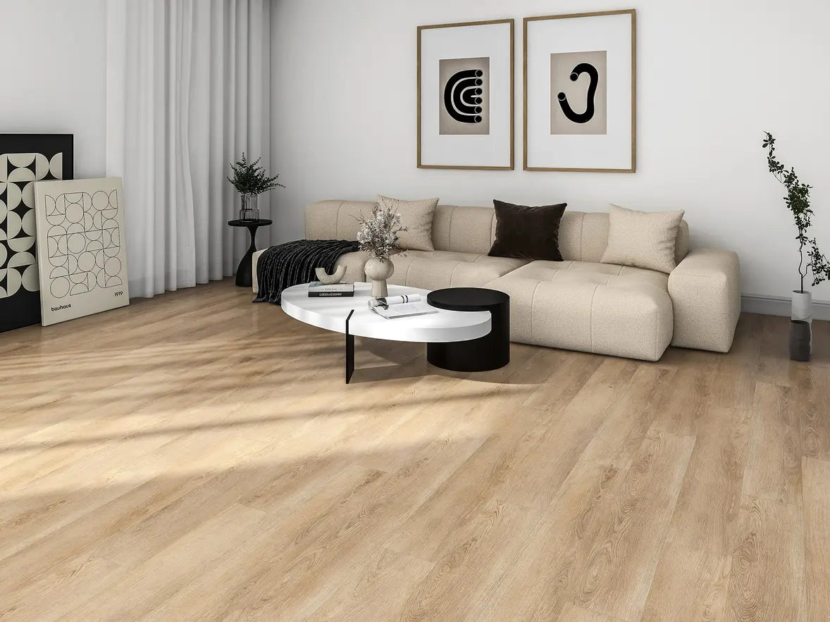 Modern living room with a beige sectional sofa, round coffee table, and decorative items.