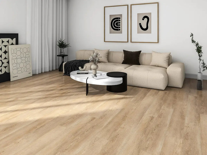 Modern living room with a beige sectional sofa, round coffee table, and decorative items.