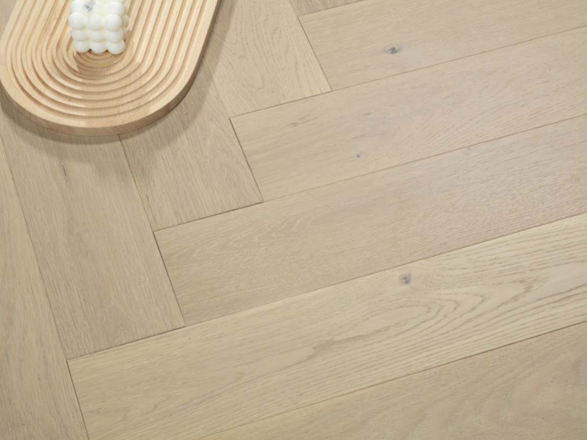 A close up of Naked Oak VIDAR premium 5” American oak engineered hardwood flooring in herringbone.