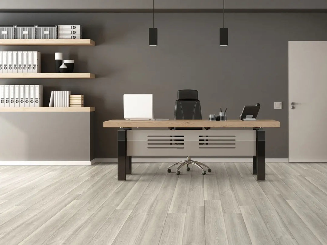 Modern office desk with chair, laptop, and office supplies in a room with shelves and a door.