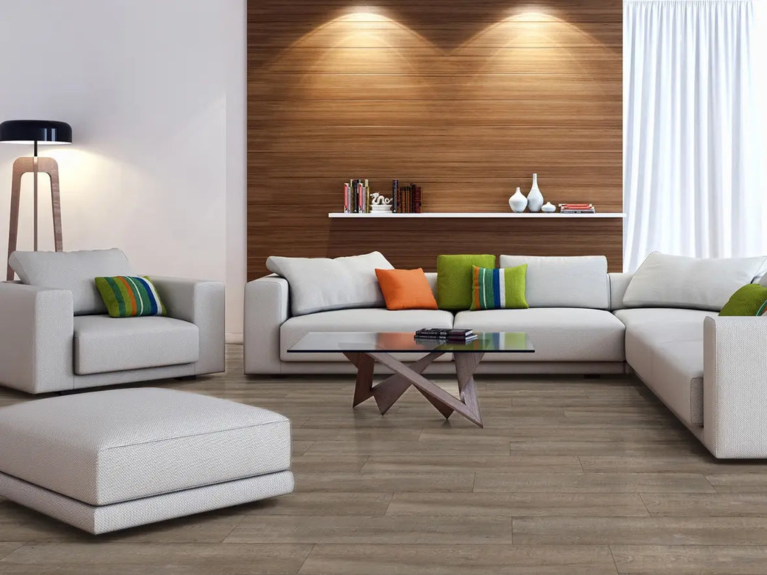 Modern living room with a sectional sofa, ottoman, and decorative pillows.