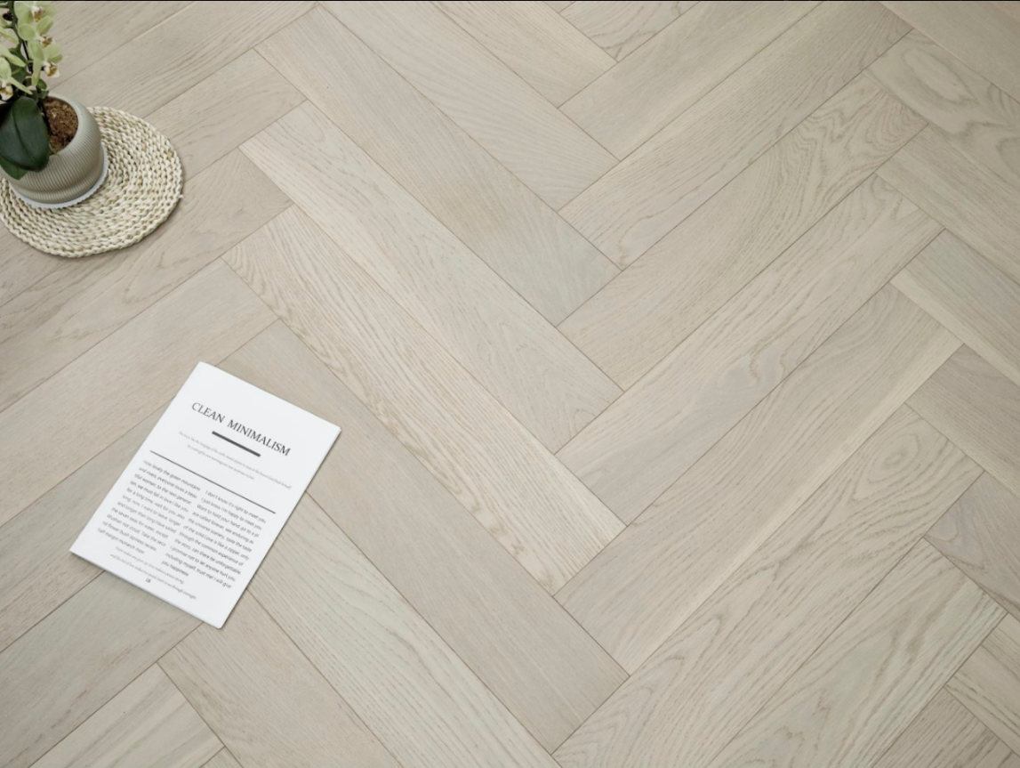 A modern room which displays the beautiful look of Pearl premium herringbone engineered hardwood flooring from Vidar.