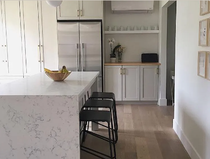 Sand Dune Fuzion engineered oak hardwood flooring from Outer Banks Elite collection installed in a modern room, featuring wide 6" x 3/4" planks, 3mm veneer layer. Canada-wide delivery available. 