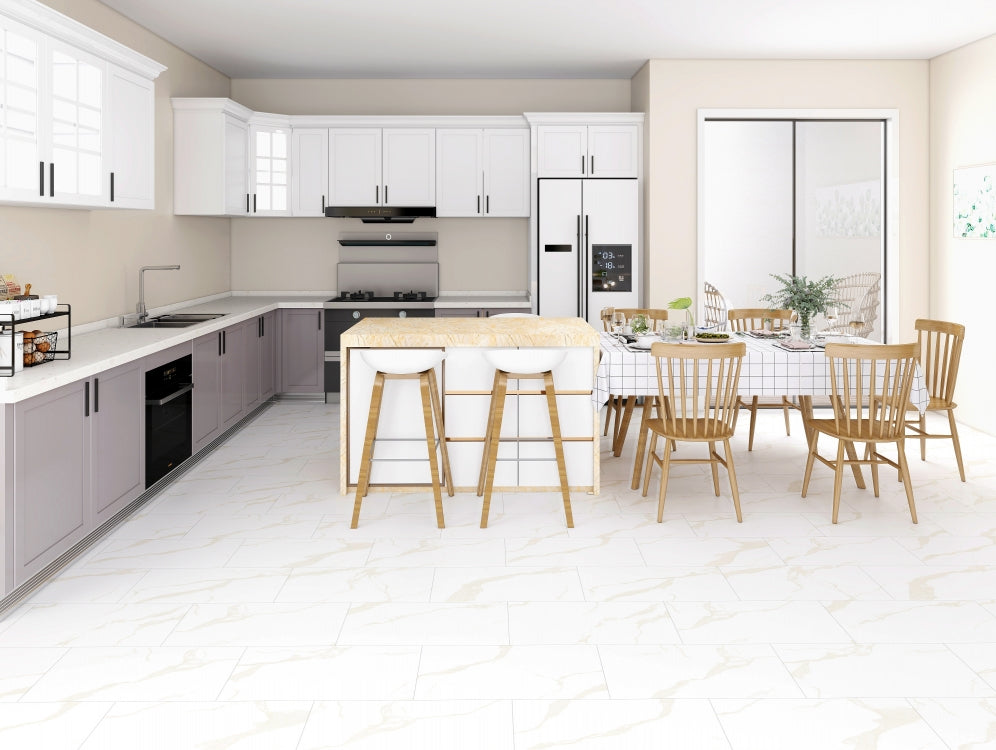 Modern kitchen with white cabinets, island, and dining area.