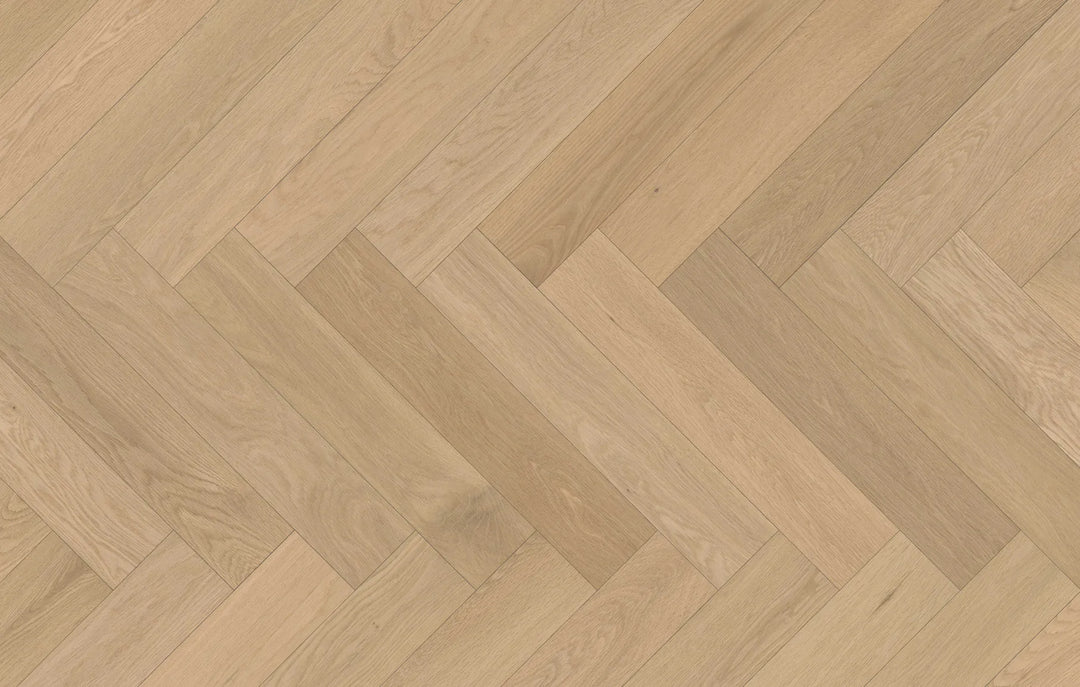 Close-up of Serene Haze engineered hardwood from Fuzion's Velvet Grove Herringbone collection. Available at Advanced Flooring Waterloo.