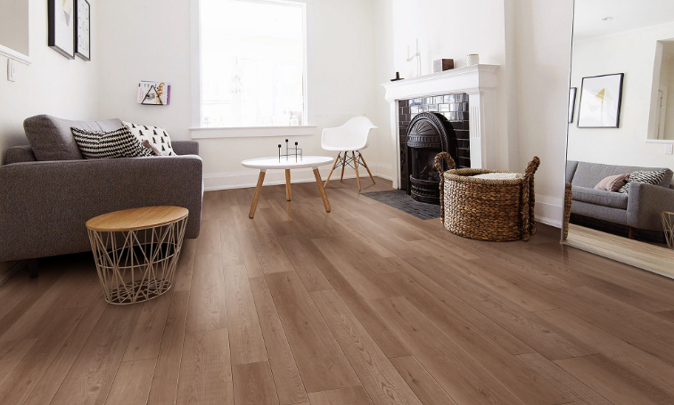 Tocoma Fuzion FuzGuard waterproof laminate flooring installed in modern living space, durable AC4 12mm planks. Available at Advanced Flooring Waterloo.