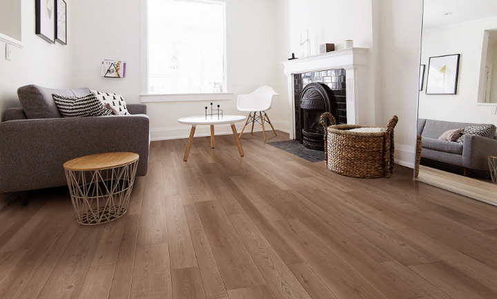 Tocoma Fuzion FuzGuard waterproof laminate flooring installed in modern living space, durable AC4 12mm planks. Available at Advanced Flooring Waterloo.