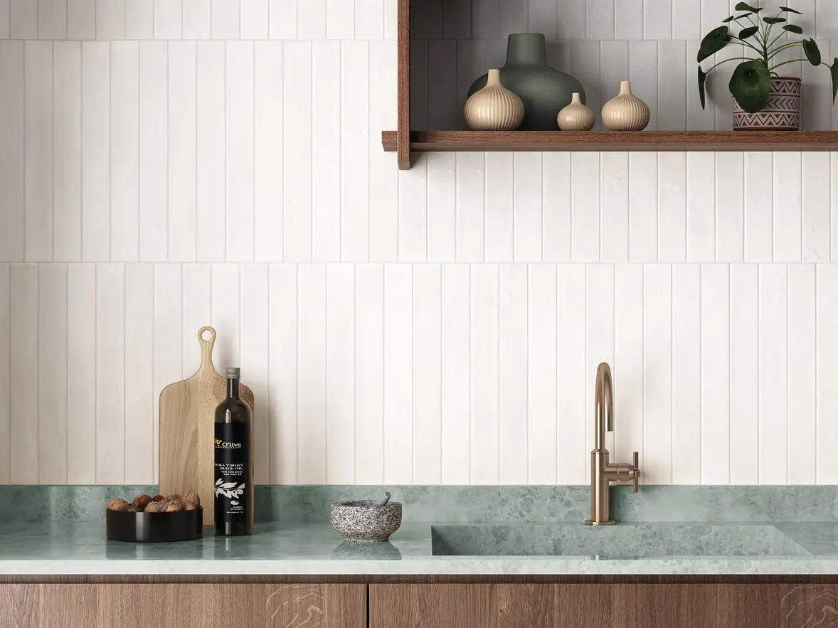 Modern kitchen with white tiled wall, wooden shelf, and marble countertop.