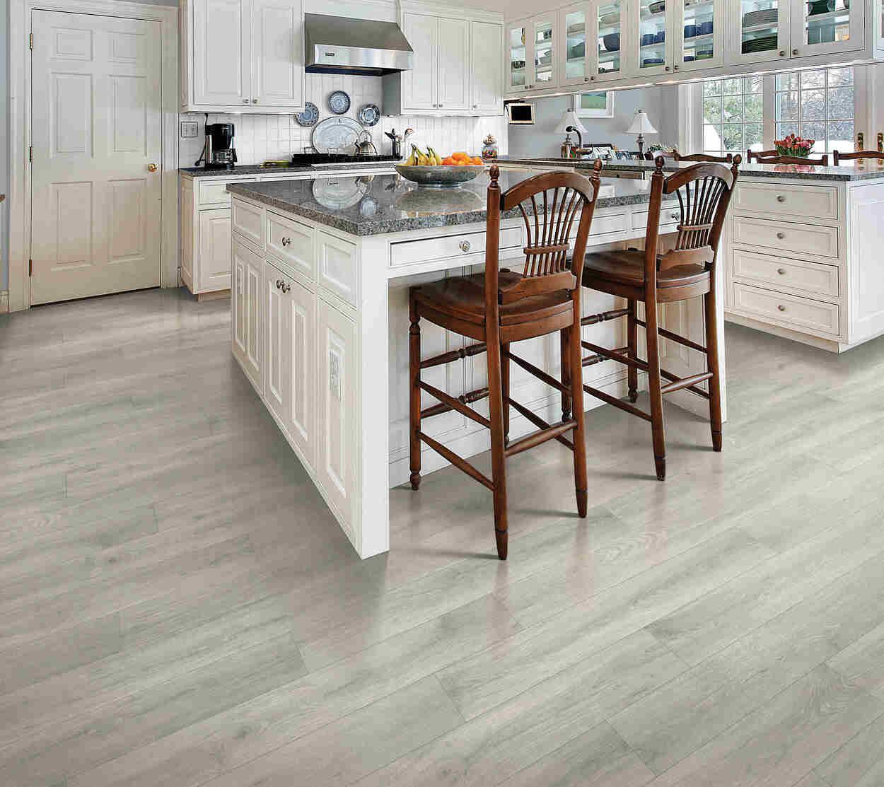 Modern kitchen with ASHLAR OAK waterproof laminate flooring by Mohawk RevWood Select RARE VINTAGE installed.