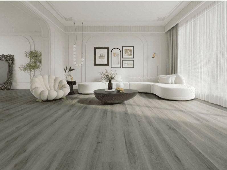A bright and inviting living room showcasing the rich, warm gray tones of Purelux vinyl plank flooring.