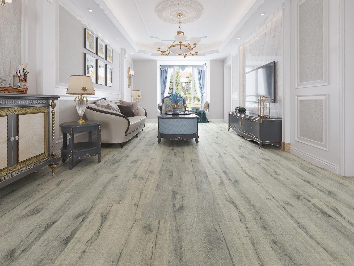 A bright and inviting room showcasing the rich, gray brown tones of Purelux laminate flooring.