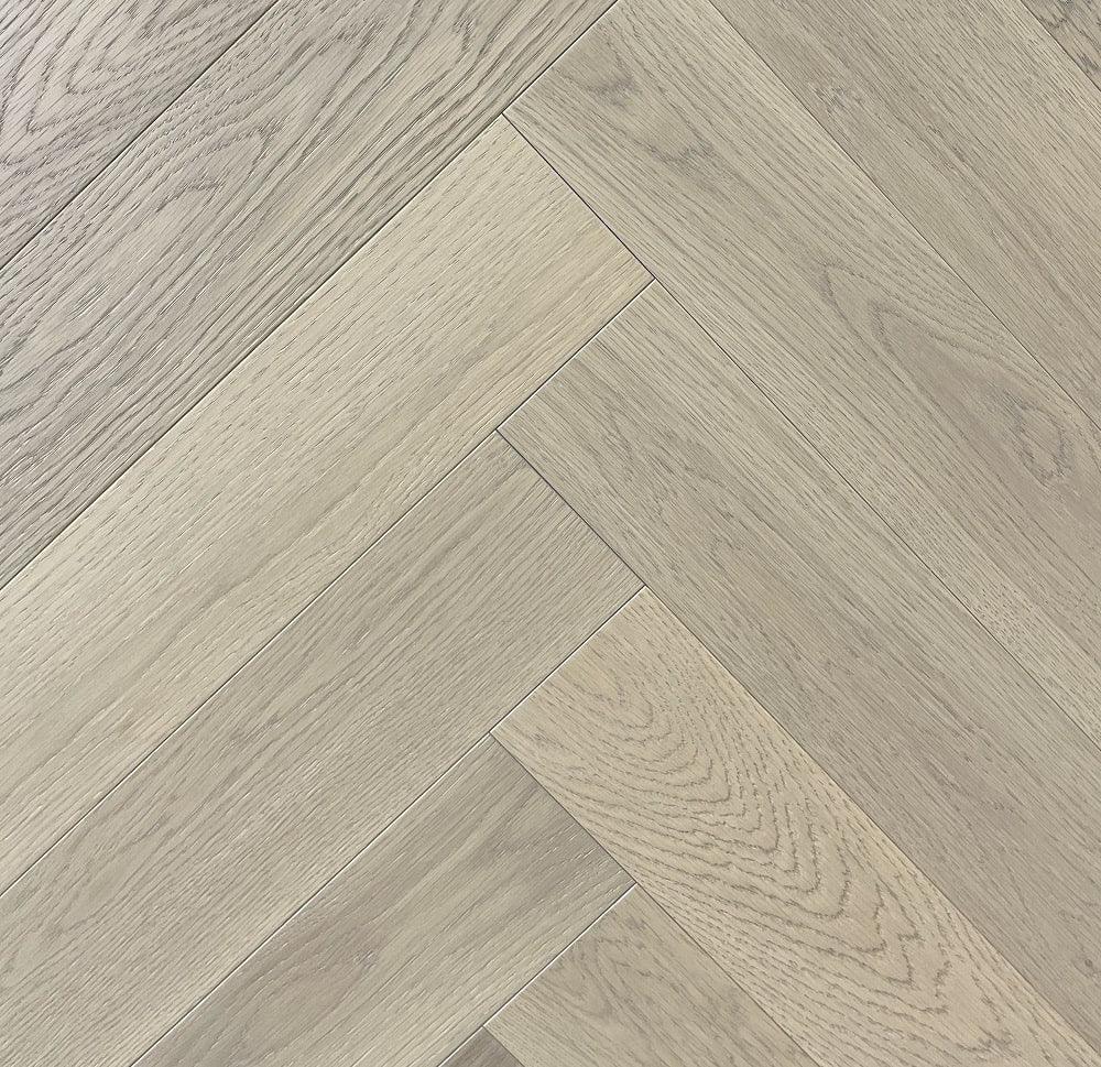A close up of Naked Oak VIDAR premium 5” American oak engineered hardwood flooring in herringbone.