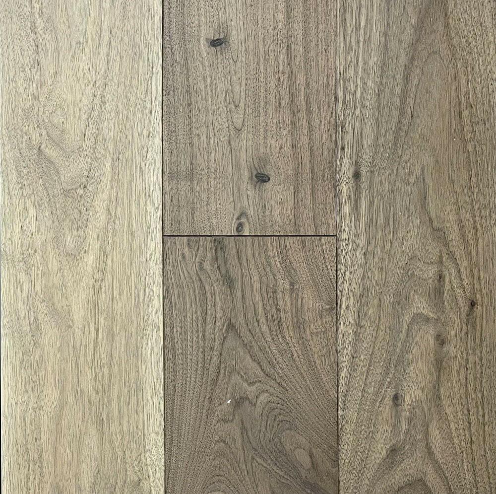 A close up of Naked Walnut 10 1/4" x 3/4" Smooth VIDAR premium American Black Walnut engineered hardwood flooring
