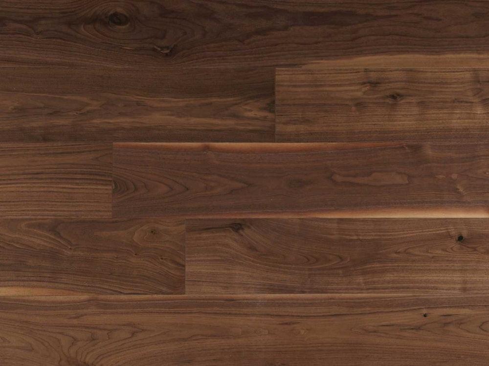 A close up of Natural 7" x 3/4" Wire Brushed VIDAR premium American Black Walnut engineered hardwood flooring