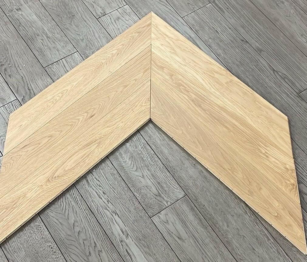 A close up of Natural VIDAR premium American oak engineered hardwood flooring in chevron.