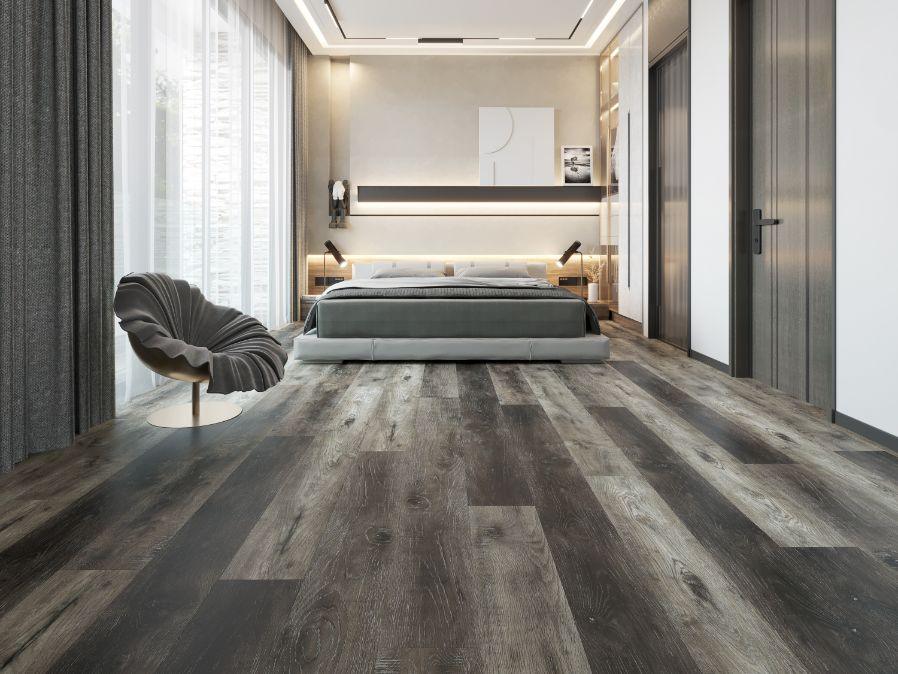 A bright and inviting bedroom showcasing the rich, gray tones of Purelux vinyl plank flooring.