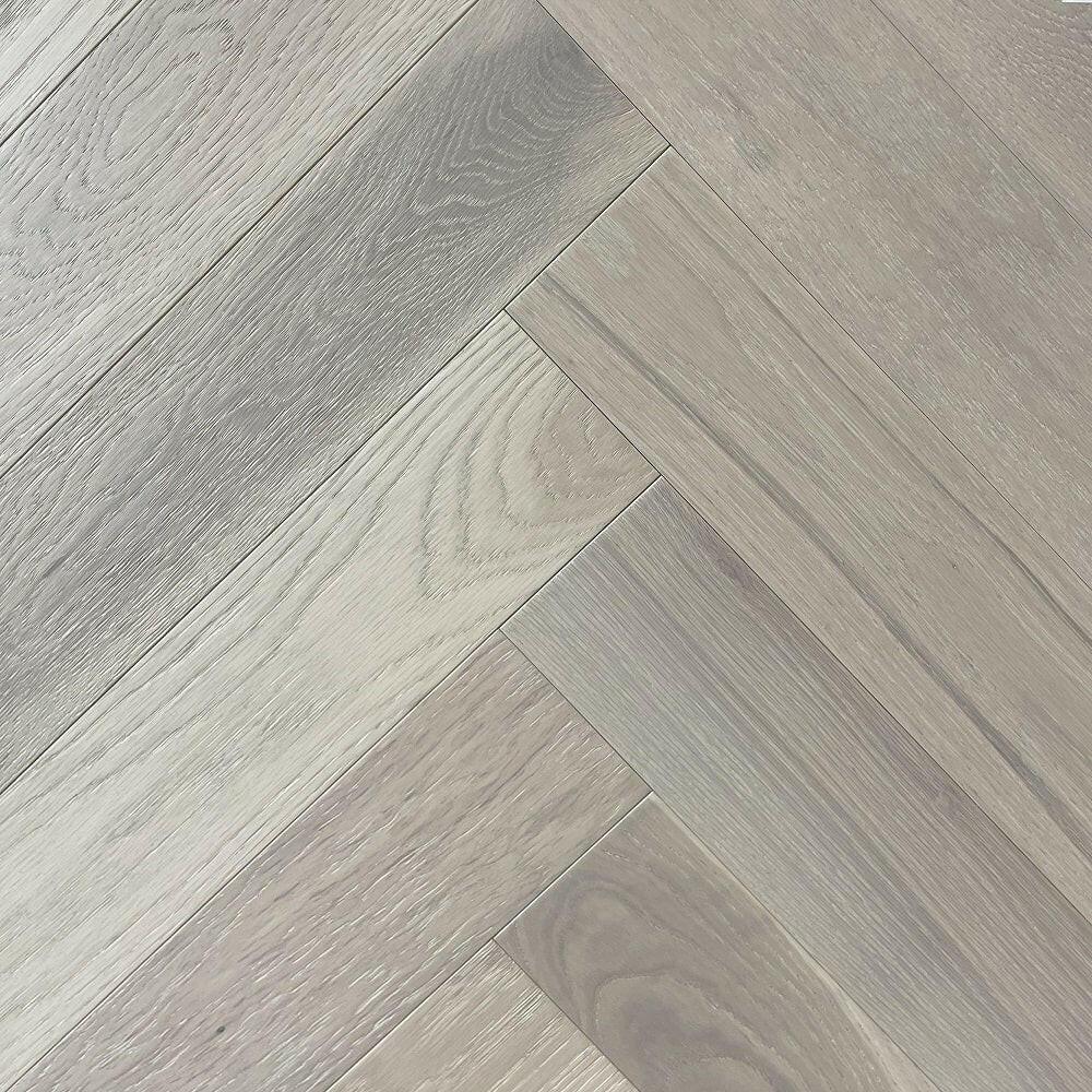 A close up of Silver Stone VIDAR premium 5” American oak engineered hardwood flooring in herringbone.