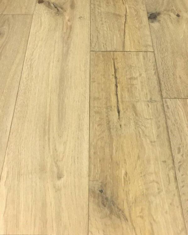 A close up of Smoked Expose BRAND SURFACES premium solid hardwood flooring from Canadian Standard.
