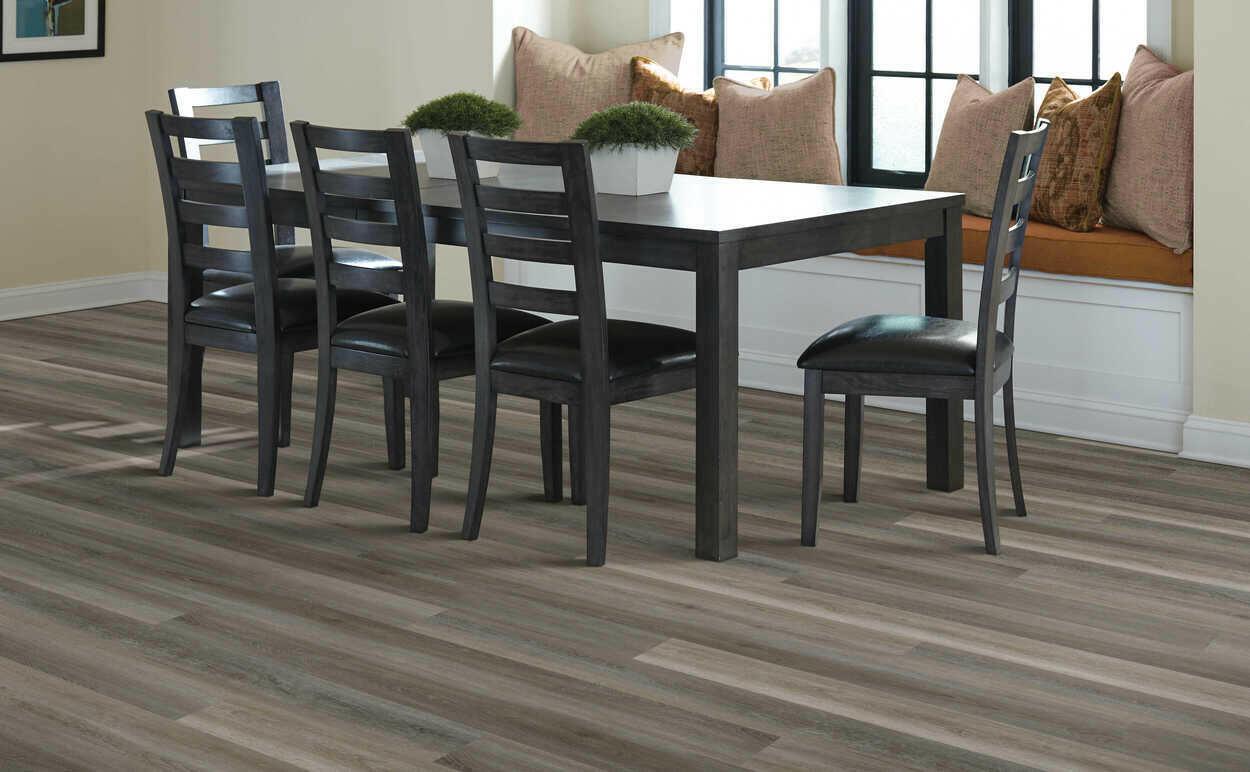 Modern room with 4.5mm vinyl plank installed in the colour Smoked Oyster by Mohawk SolidTech sold by Advanced Flooring in Kitchener-Waterloo.