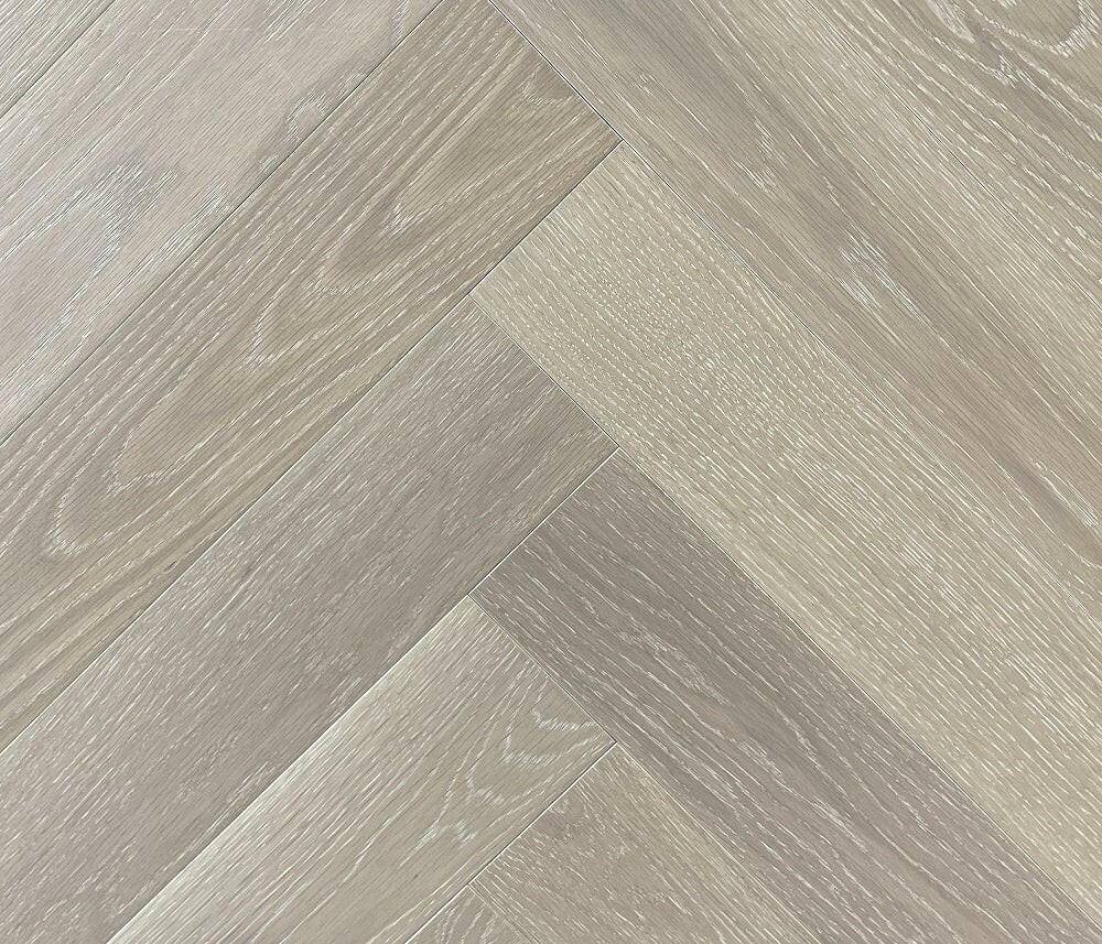A close up of Wheat Berry VIDAR premium 5” American oak engineered hardwood flooring in herringbone.